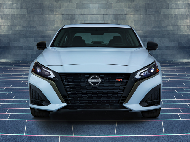 Front view of a white 2024 Nissan Altima parked in a brick garage. | Nissan dealer in Altoona, PA | Courtesy Nissan PA
